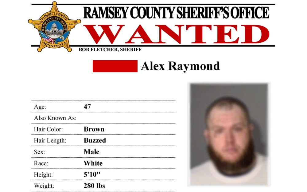 A screenshot from the Ramsey County Sheriff’s Office featuring a 47-year-old male with brown buzzed hair, white skin, a beard, and a picture of his face.